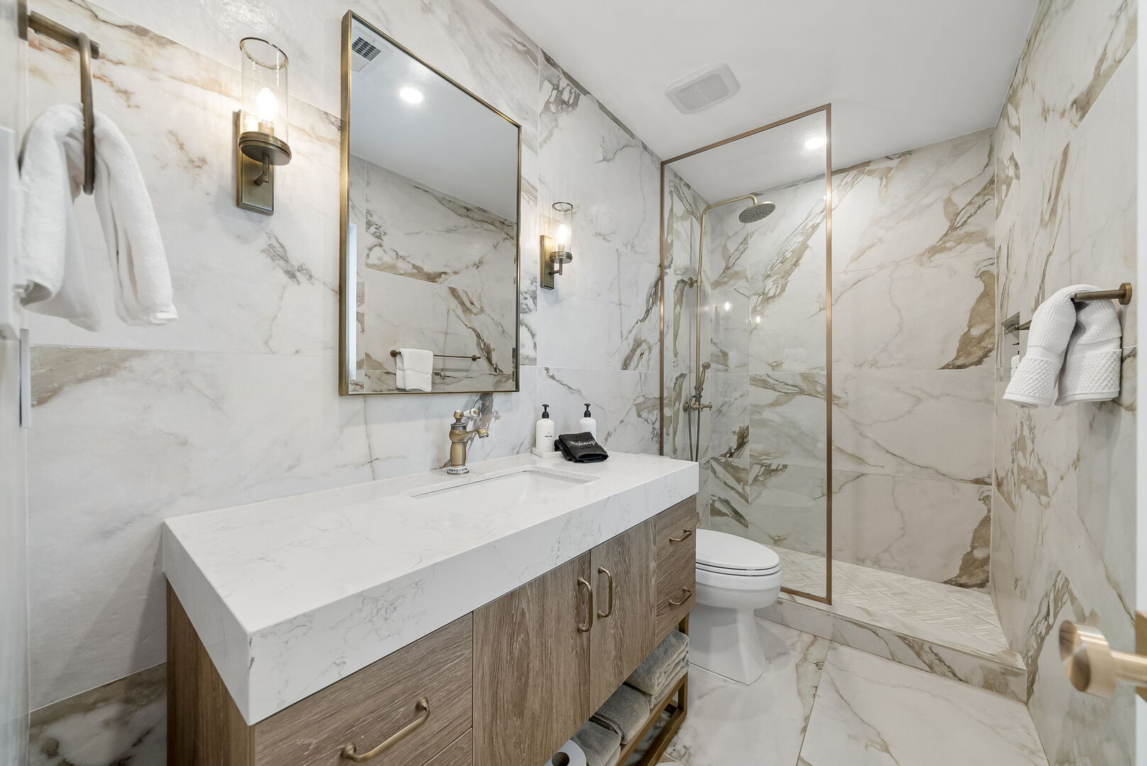 Bathroom with luxurious finishes. Features a walk-in shower.