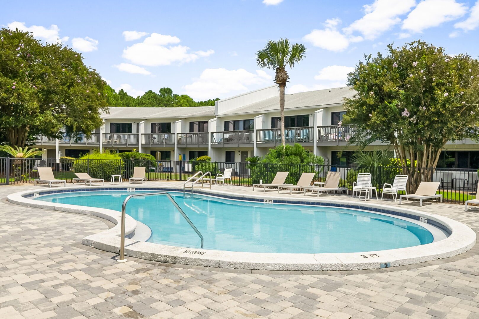 Community pool with lounge chairs.