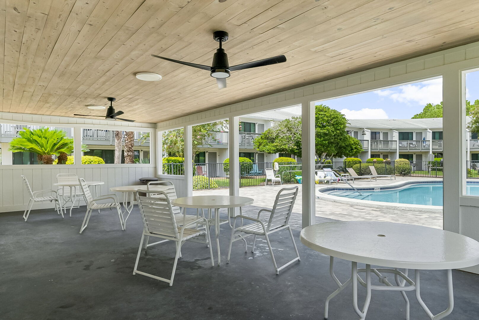 Covered pool house with seating.