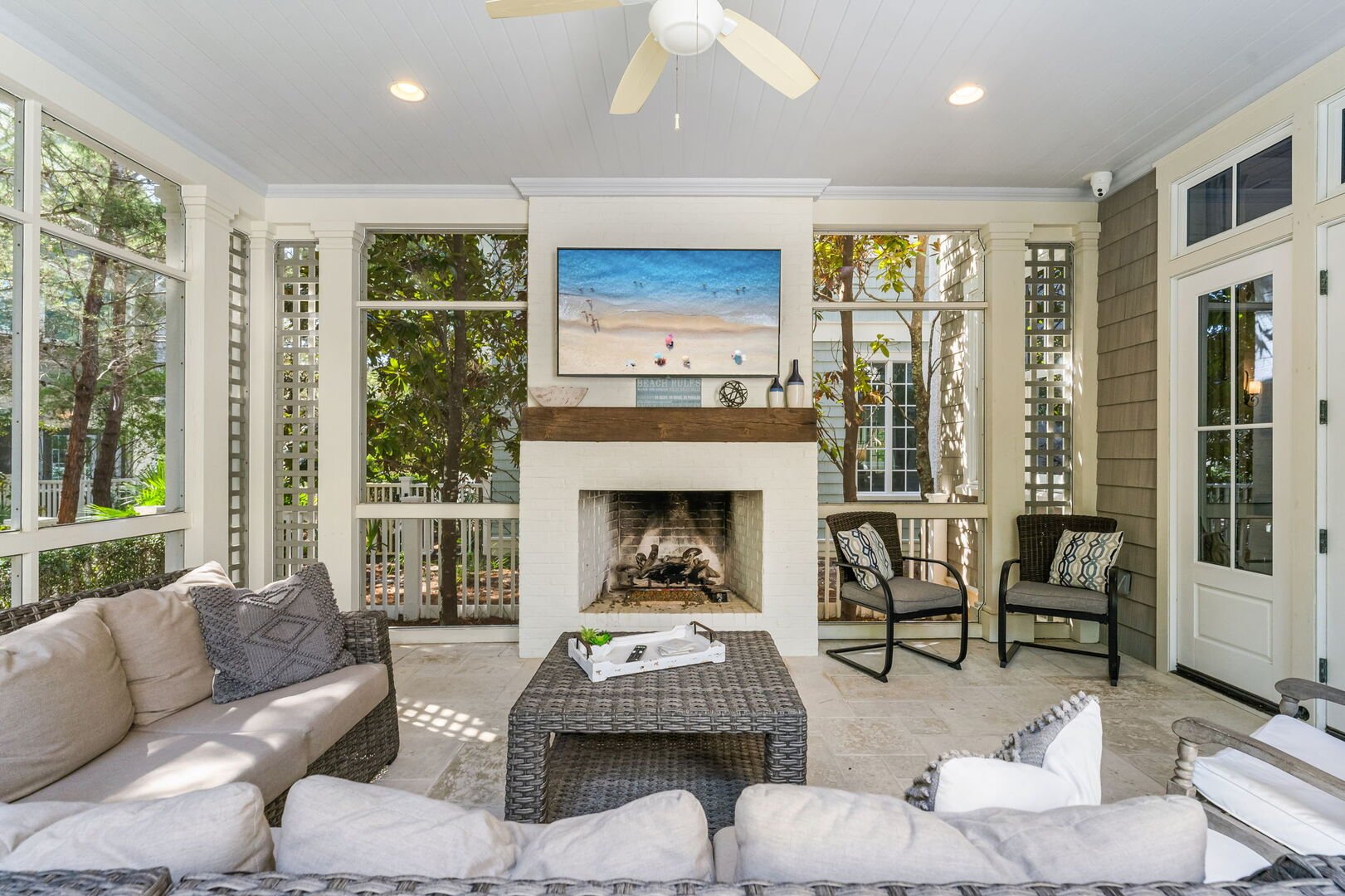 Screened-in patio off living room with seating for all.