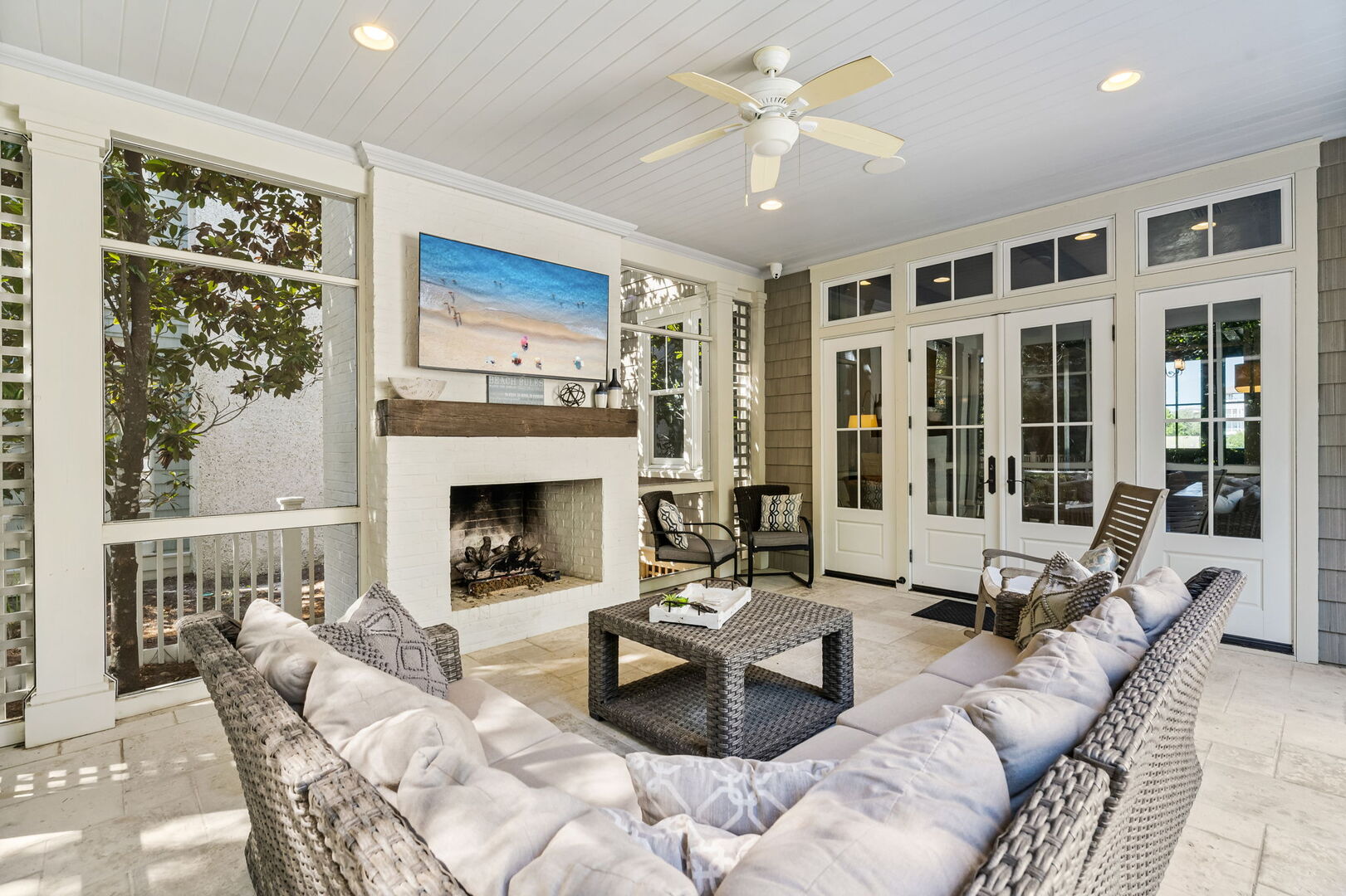 Outdoor screened in porch with smart TV.