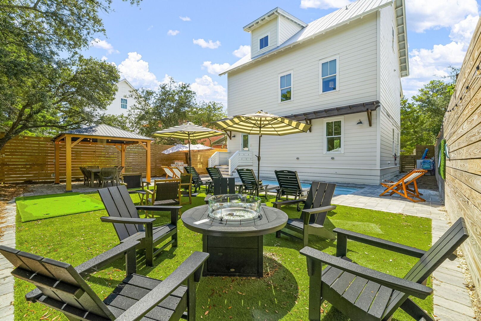 Backyard features firepit and plenty of seating areas, perfect for entertaining.