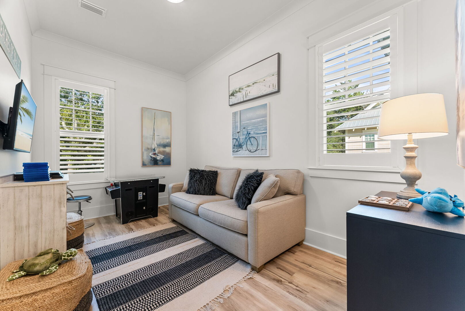Loft living area with a pacman game & TV perfect for movie nights!