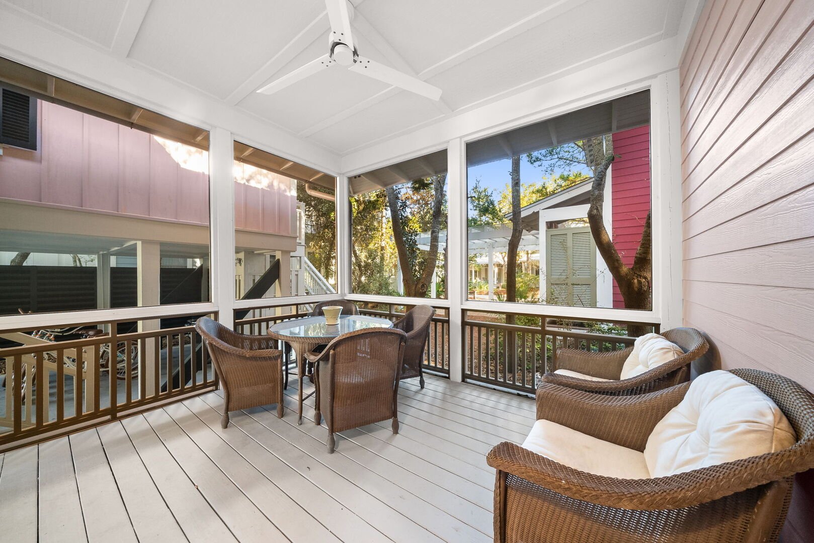 Screened in & covered patio with seating.