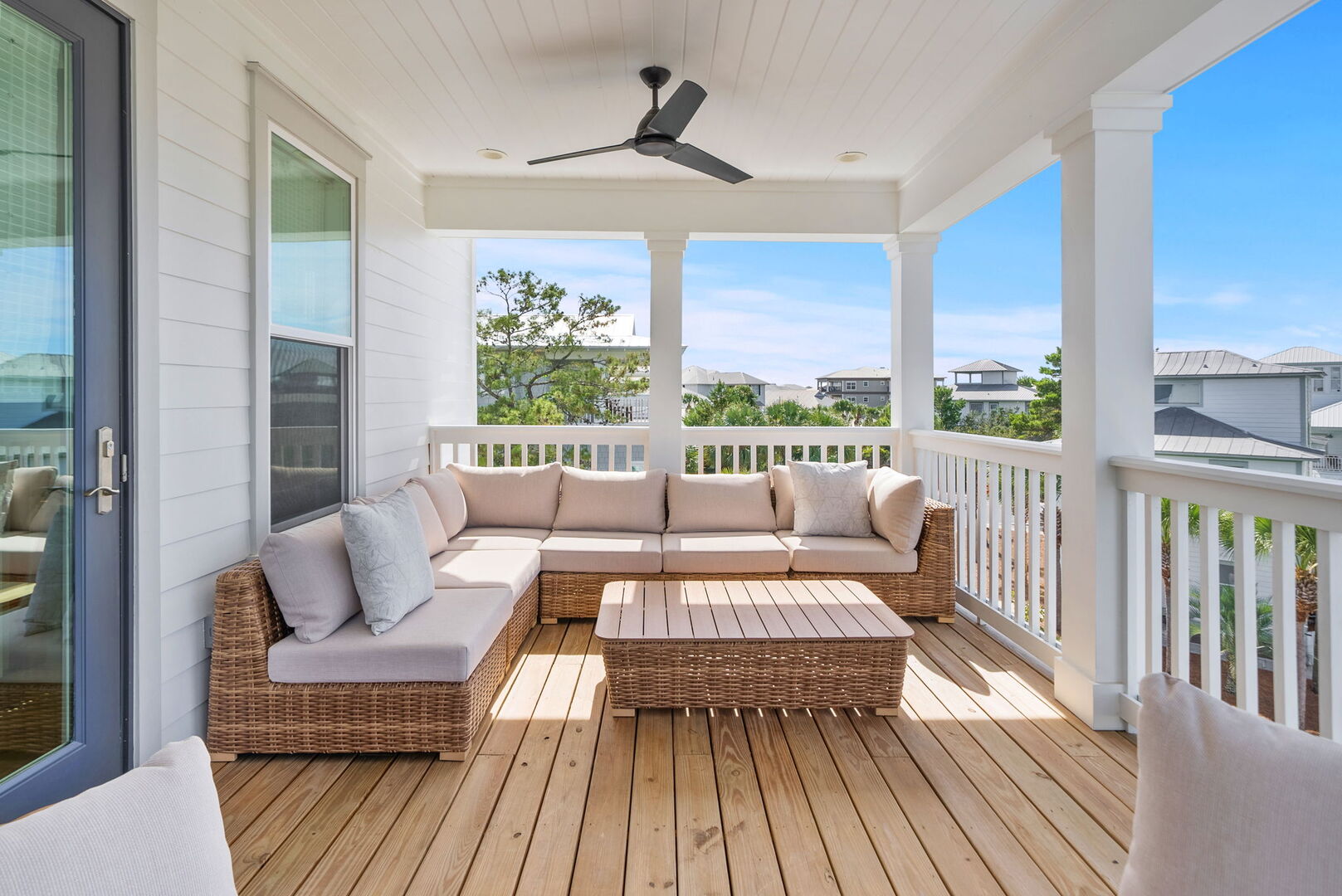 Third floor covered porch with seating.