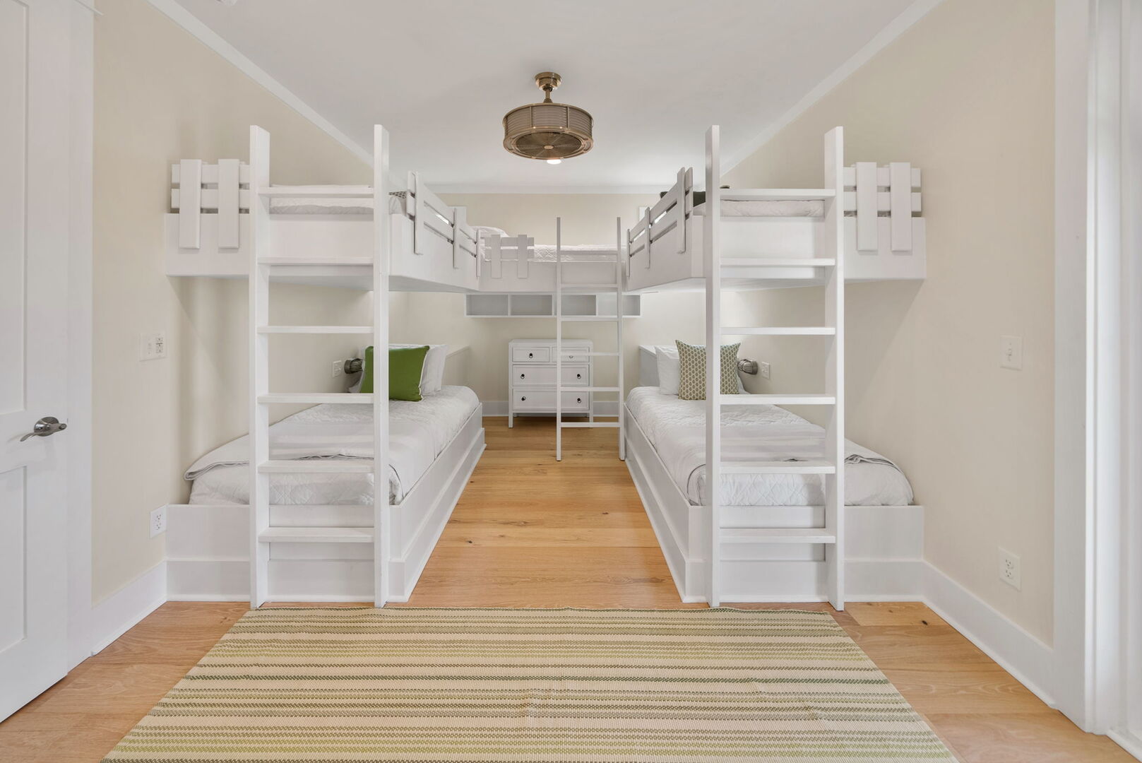 Bedroom #2 features (5) twin beds (built in bunks) with ensuite, smart tv, & access to covered balcony.
