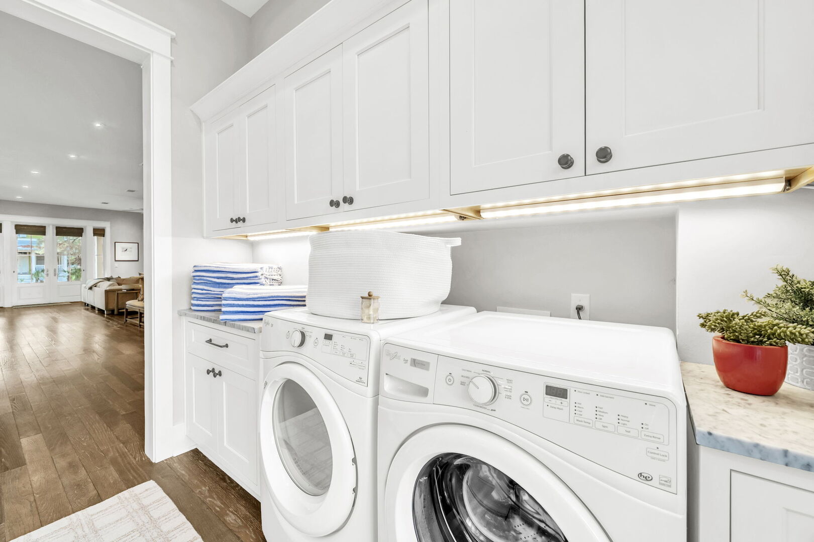 First floor laundry room features full sized washer and dryer