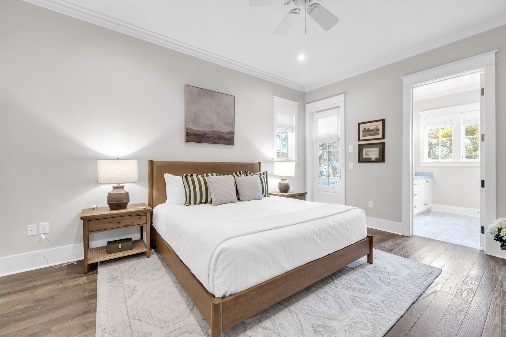 First floor bedroom features a king bed, smart tv, walk-in closet and ensuite.